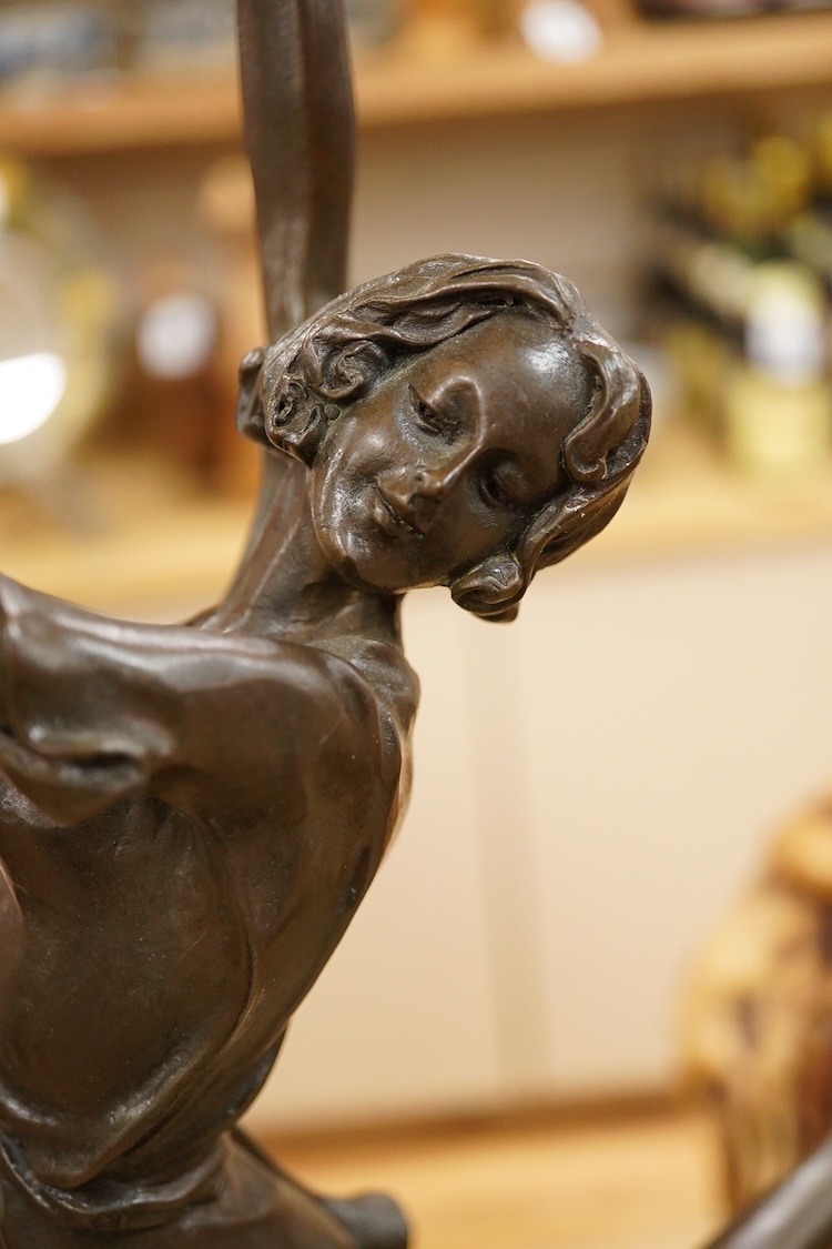 After Bruno Zach (1891-1945), an Deco style bronze of a dancing lady, raised on a marble and slate base, 65cm high